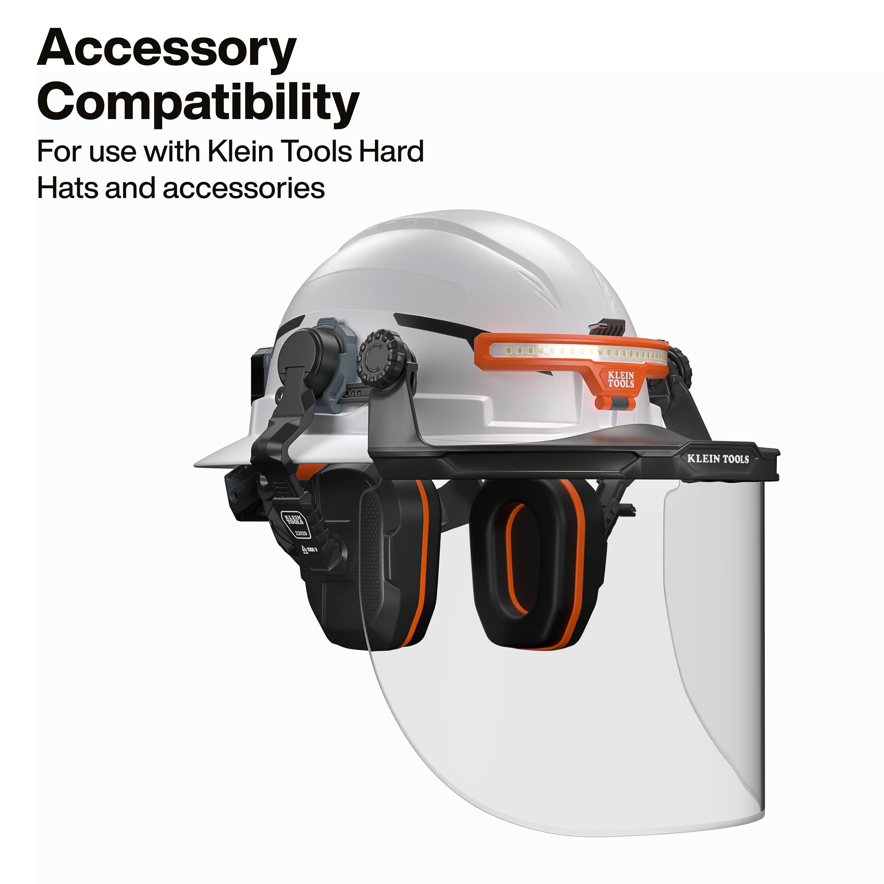 Full accessory compatibility demonstration showing the 22029 earmuffs integrated onto a hard hat along with a Klein Tools headlamp and a clear protective face shield for total head and face protection.