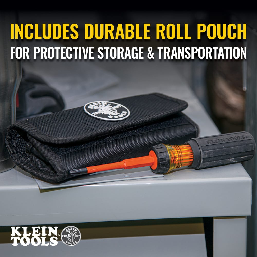 Klein Tools 32288 multi-blade insulated screwdriver tool kit shown in a jobsite environment resting on top of a gray metal electrical enclosure box, featuring a black canvas roll pouch with a stitched circular logo patch alongside a fully assembled 1000-volt orange driver shaft locked inside the black Cushion-Grip handle.