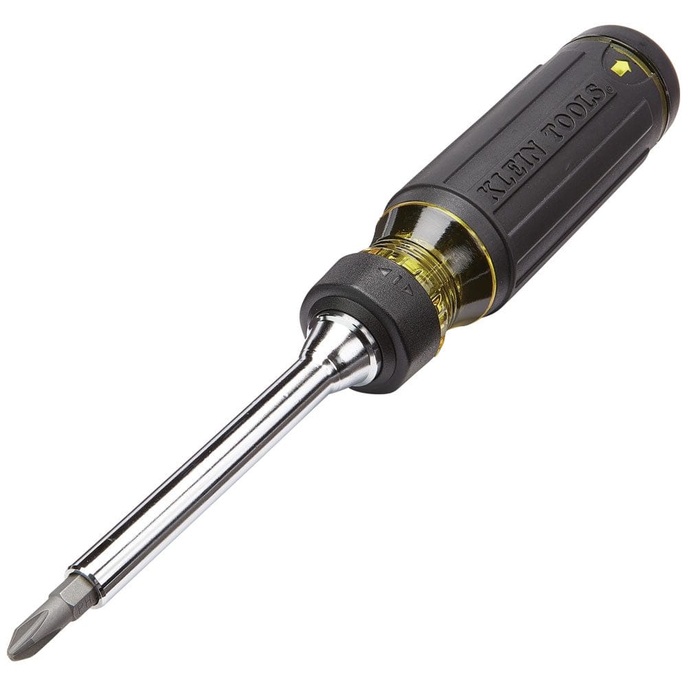 Angled studio shot of the Klein Tools 15-in-1 ratcheting screwdriver featuring a black cushion-grip handle, yellow accents, and a Phillips bit inserted.