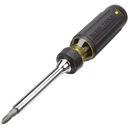 Angled studio shot of the Klein Tools 15-in-1 ratcheting screwdriver featuring a black cushion-grip handle, yellow accents, and a Phillips bit inserted.