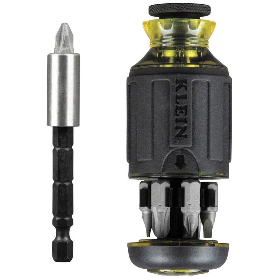 A black and yellow Klein Tools stubby multi-bit screwdriver handle with industrial-strength bits stored in the base, shown next to a removable chrome impact-rated shank holding a Phillips bit.