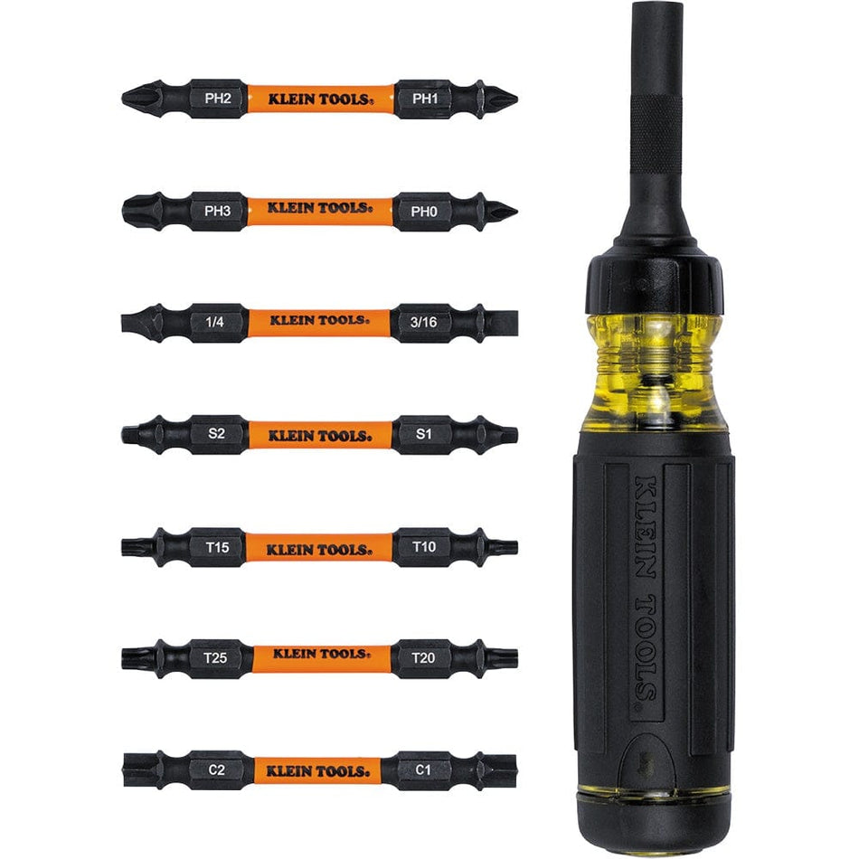 The Klein Tools 15-in-1 ratcheting screwdriver displayed vertically alongside its seven included double-ended impact-rated bits, which are arranged in a column to show the variety of tips.