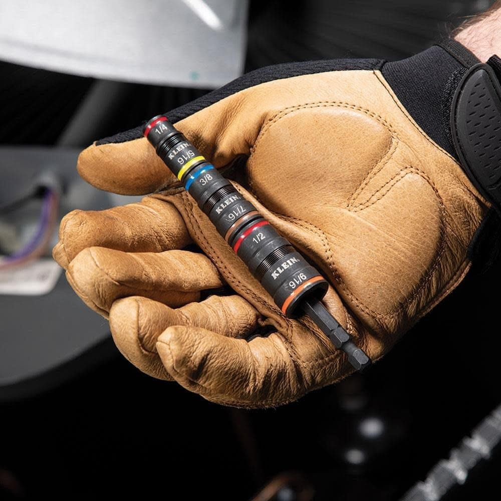 A person wearing a tan and black work glove holds the complete 7-in-1 impact socket set in their palm, illustrating its compact and portable design.