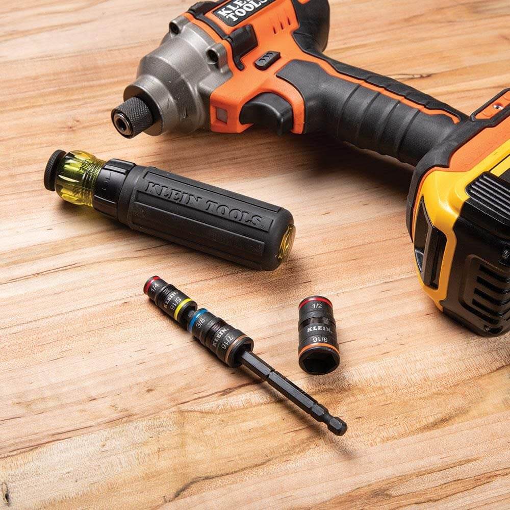 The 7-in-1 flip socket set shown disassembled on a wooden work surface next to a cordless impact driver and a manual quick-connect handle.