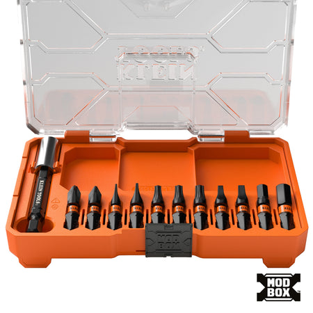 The Klein Tools 33801S 12-piece screwdriver bit set is displayed in an open, orange MODbox compatible storage case, featuring eleven impact-rated S2 steel bits and one magnetic bit holder organized in secure-pivot slots for easy access.