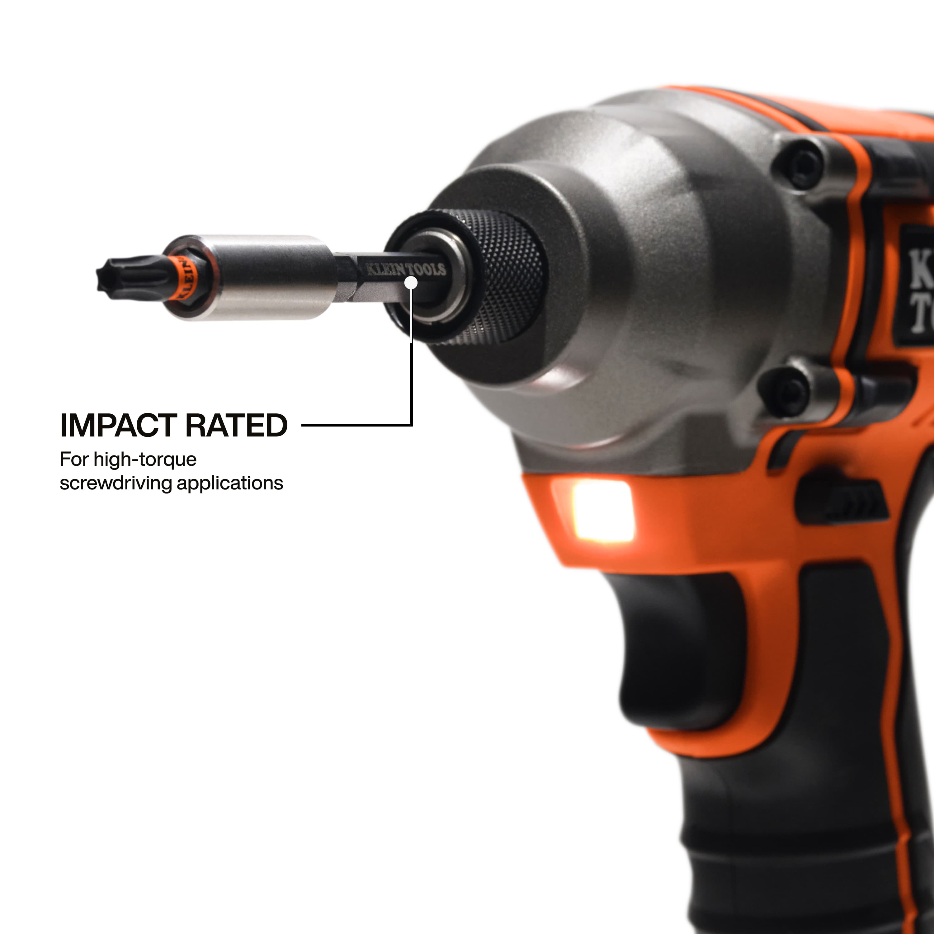 Close-up action shot of a Klein Tools impact-rated bit being used in a cordless impact driver, emphasizing its high-torque capability for demanding professional screwdriving applications.