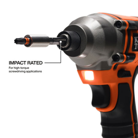 Close-up action shot of a Klein Tools impact-rated bit being used in a cordless impact driver, emphasizing its high-torque capability for demanding professional screwdriving applications.