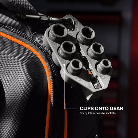 An in-use application shot showing the Klein Tools Grab-And-Go socket sleeve clipped onto the side of a black job site backpack using the carabiner, demonstrating quick access to the metric sockets for increased job site productivity.