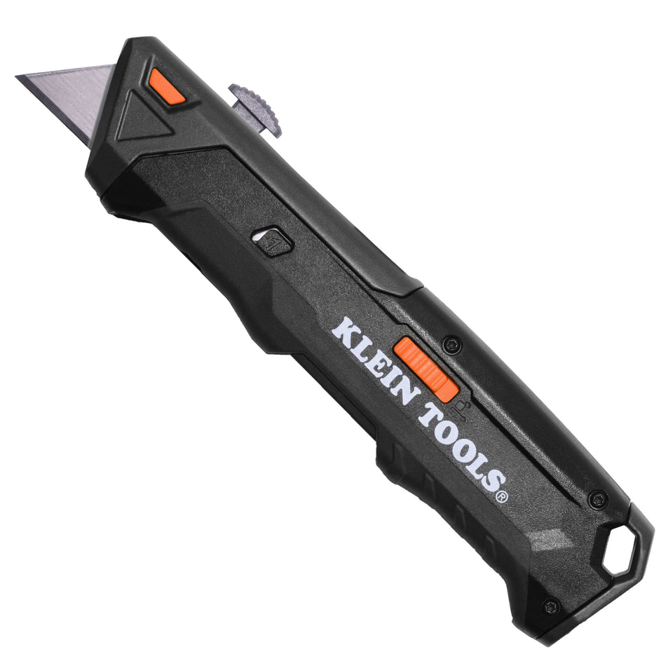 A professional side profile of the Klein Tools 44308 auto-loading retractable utility knife, featuring a rugged black housing, ergonomic thumb slide for blade extension, and a high-visibility orange quick-release button for the blade magazine.