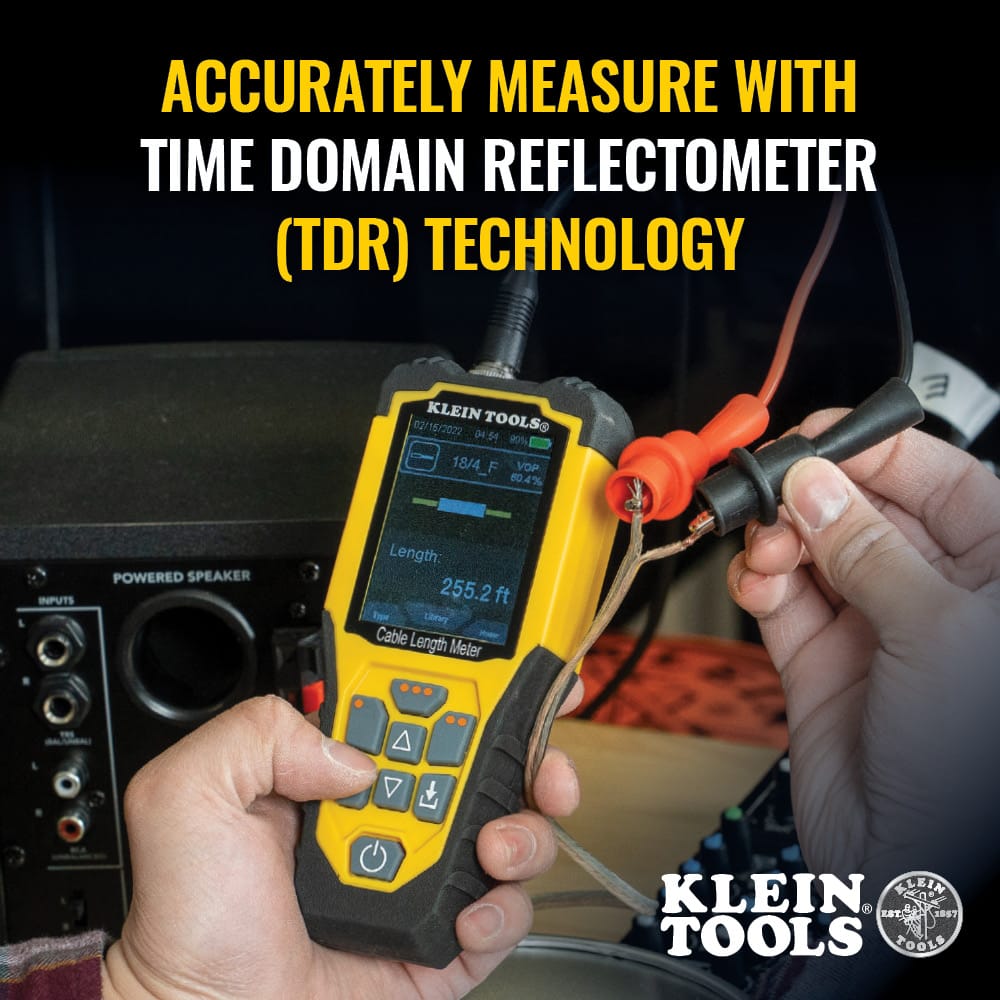 Action shot of a technician using the 501915 meter to measure a specific wire run. The high-resolution color LCD screen displays a clear length reading of 255.2 feet, illustrating the precision of Time Domain Reflectometry technology when used for professional electrical diagnostics.