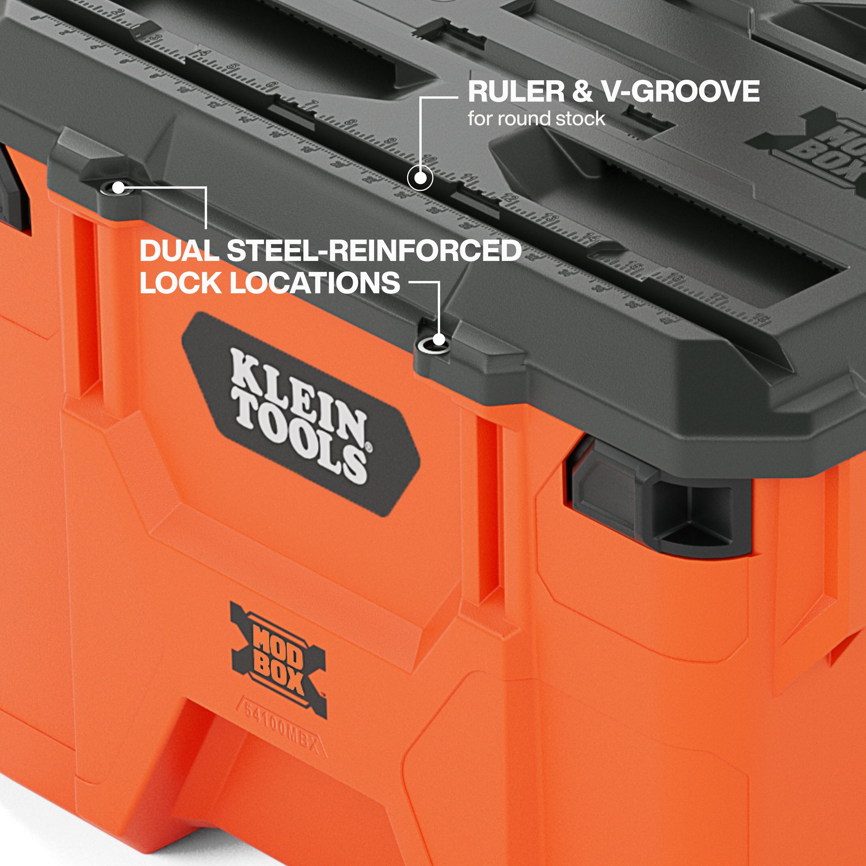 Close-up detail of the MODbox workstation lid highlighting the integrated molded-in ruler, the V-groove for securing round stock, and the dual steel-reinforced lock locations for jobsite security.