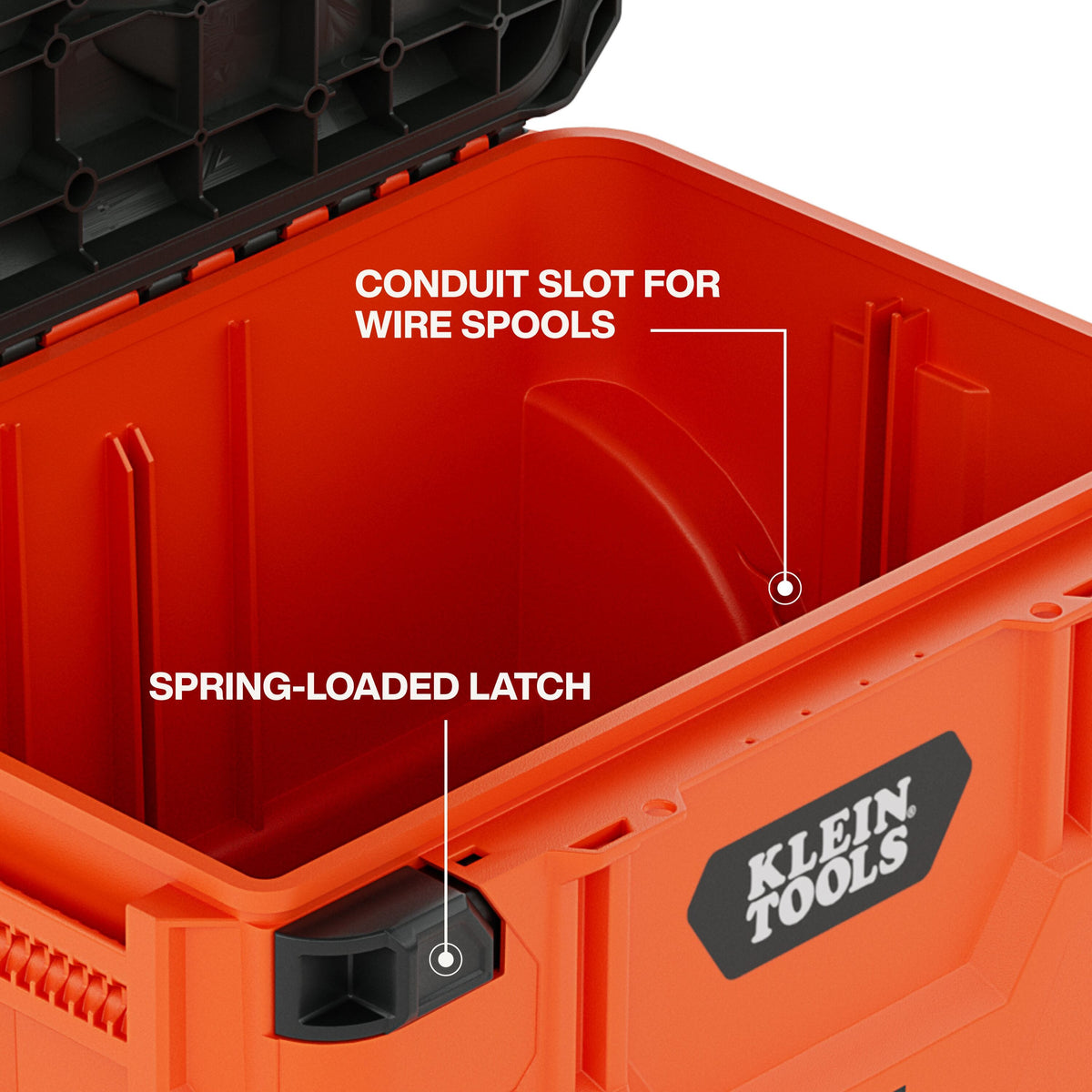 Interior detail shot of the Klein Tools MODbox highlighting the conduit slot for wire spools and the heavy-duty spring-loaded latch mechanism for secure tool storage.