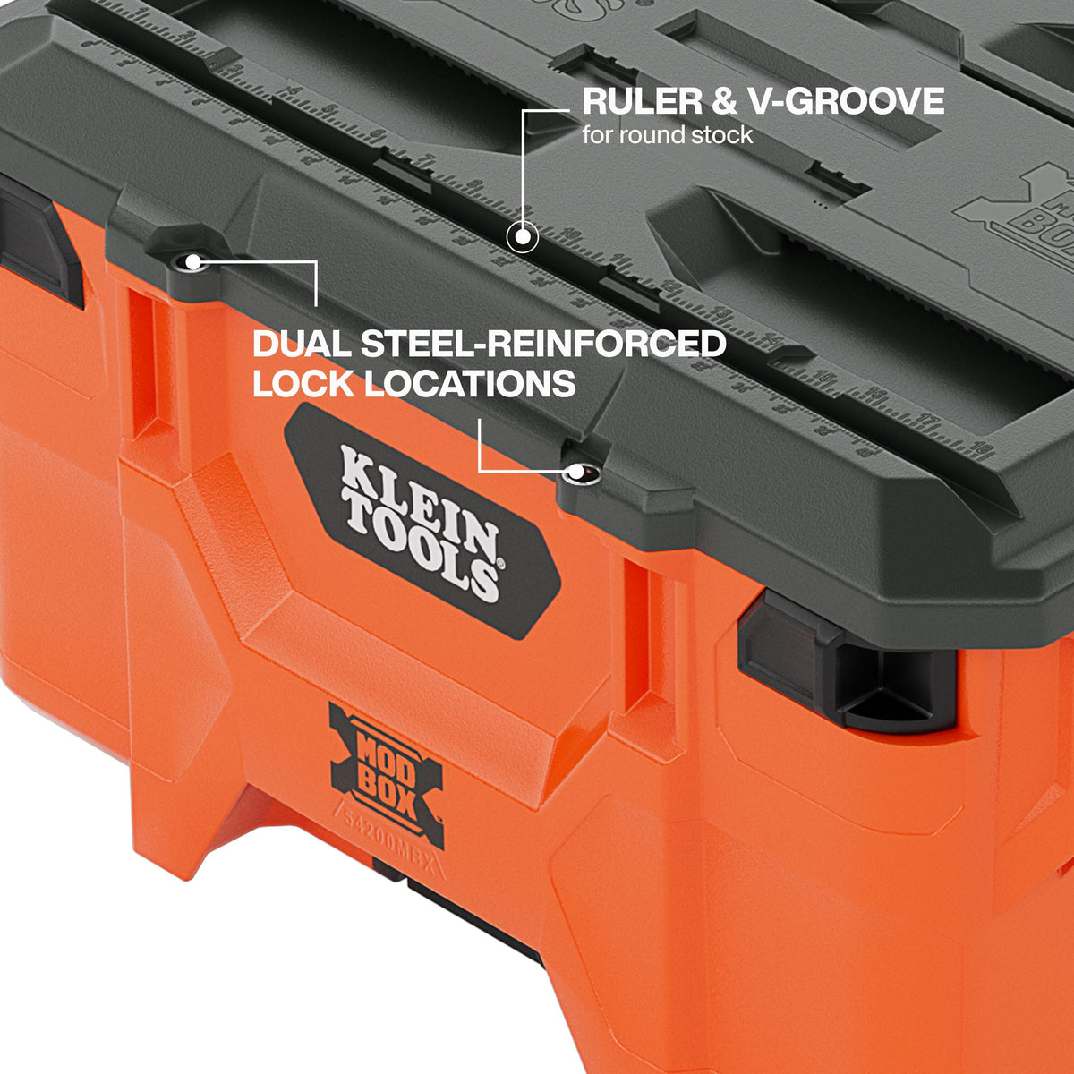 Workstation lid detail highlighting the dual steel-reinforced lock locations for jobsite security and the integrated V-groove and ruler used for cutting round stock.
