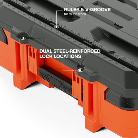 Close-up detail of the MODbox workstation lid highlighting the dual steel-reinforced lock locations and the integrated ruler and V-groove designed for cutting round stock.