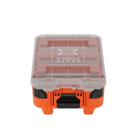Front perspective view of the orange Klein Tools 54500MBX MODbox half-width tall component box featuring a clear impact-resistant lid and heavy-duty front latches for small parts organization.