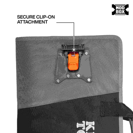 A close-up view of the back of the tool apron, highlighting one of the two heavy-duty orange and black secure clip-on attachment points used to fasten the apron to the MODbox rail system.