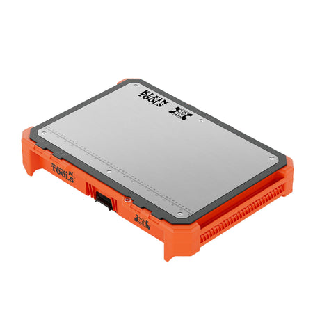 Perspective view of the Klein Tools 54826MB MODbox tray work top featuring a heavy-duty stainless steel surface with an integrated measuring ruler and orange impact-resistant polymer housing.