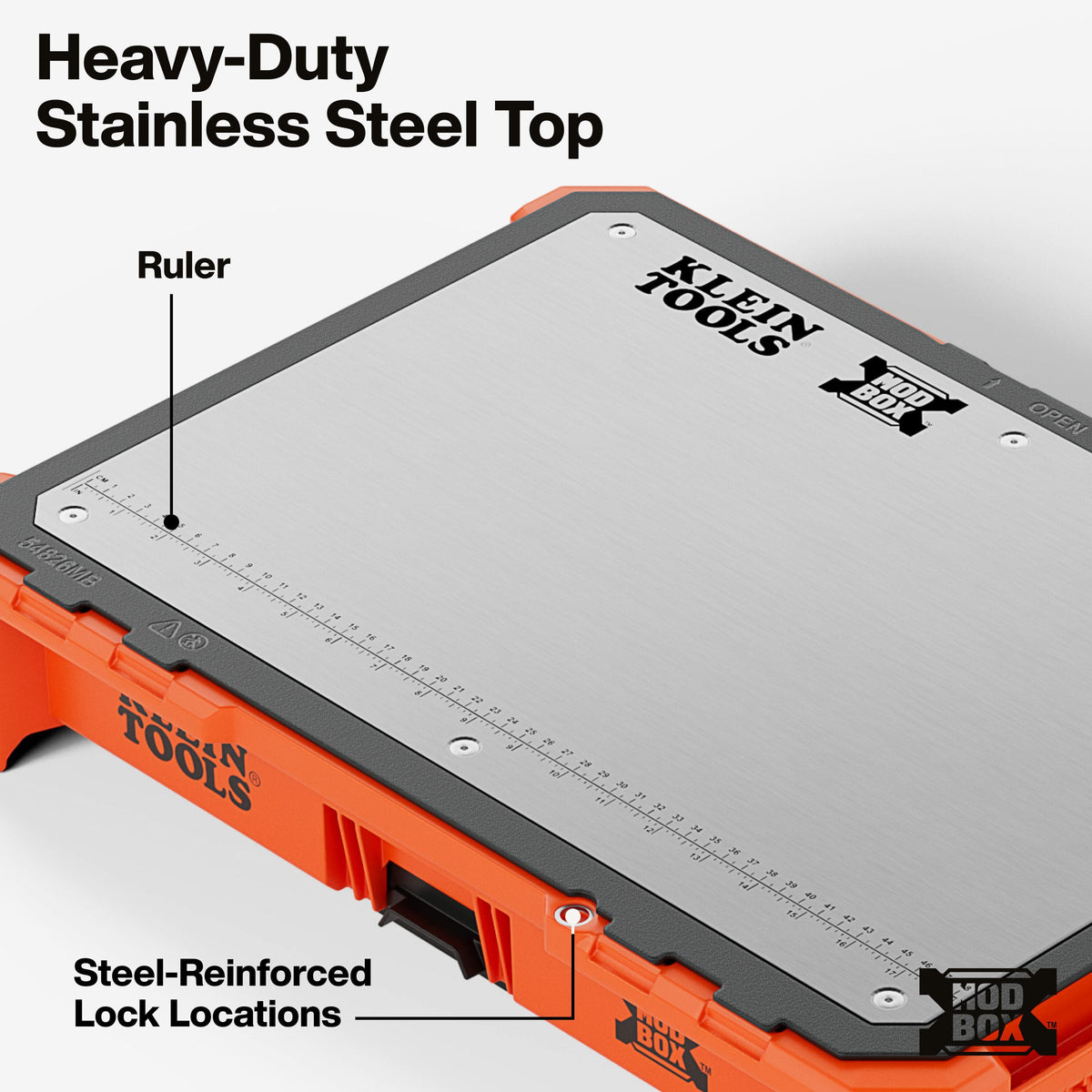 Close-up detail of the heavy-duty magnetic stainless steel top highlighting the molded-in ruler and dual steel-reinforced lock locations for securing the modular workstation.
