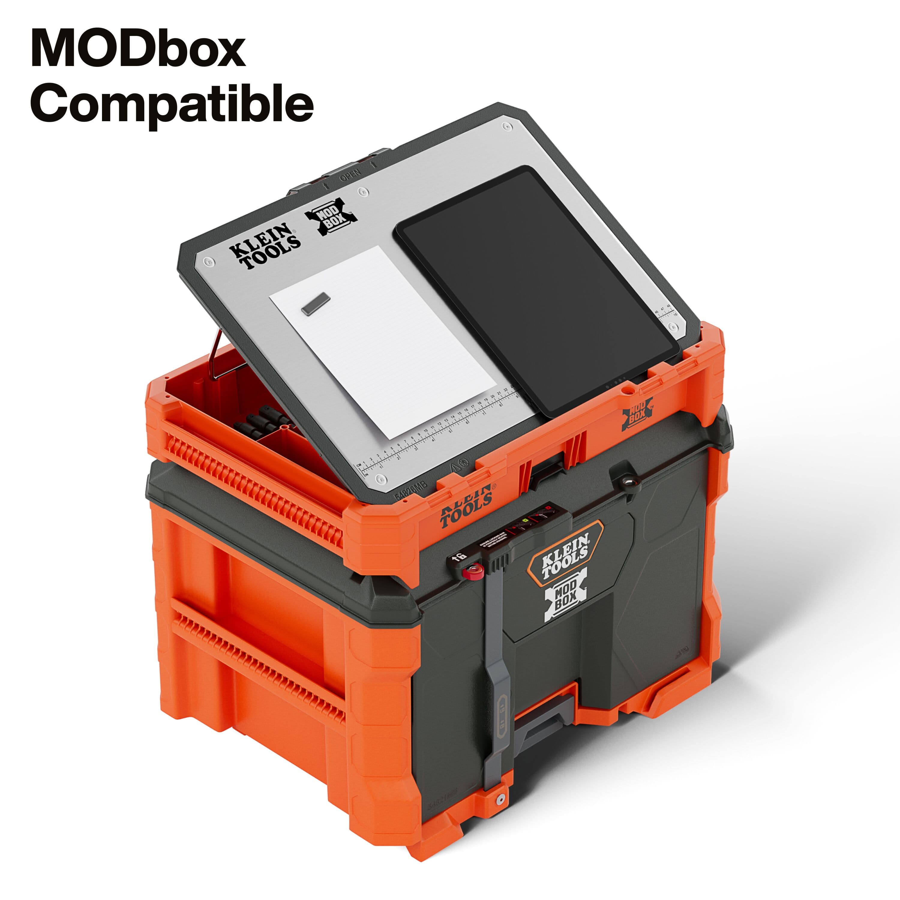 The 54826MB MODbox tray work top shown in the angled easel position connected to a rolling toolbox stack, functioning as a hands-free holder for technical drawings and a tablet.