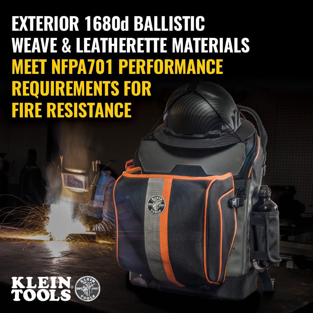 A lifestyle shot showing the backpack in a metal fabrication shop. The text overlay confirms the exterior 1680d ballistic weave and leatherette materials meet NFPA701 performance requirements for fire resistance, essential for ironworkers and welders.