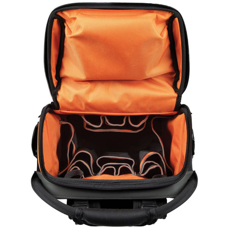 An overhead view looking into the fully unzipped main compartment of the tool backpack. The high-visibility orange interior features multiple tiered pockets for organized storage of hand tools, ensuring everything is easily accessible in low-light environments.