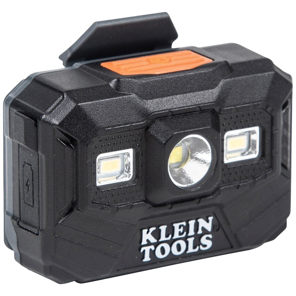 A high-resolution product shot of the black Klein Tools rechargeable headlamp, showing the three LED lenses on the front and the orange power button on top.