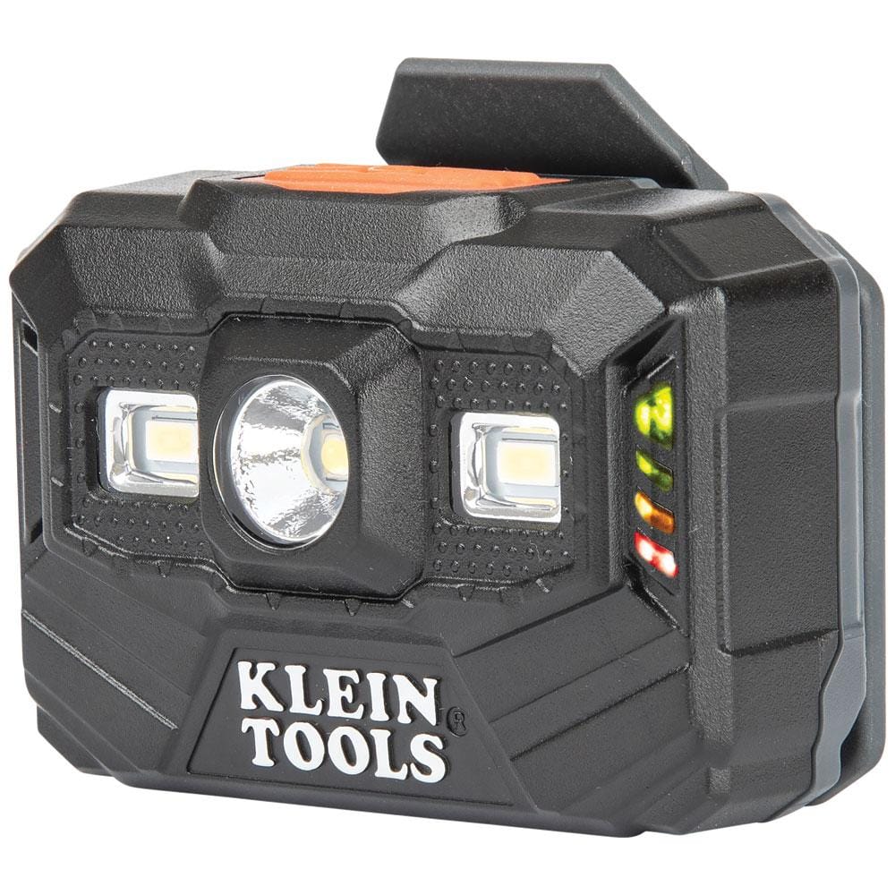 Perspective view of the black Klein Tools 56062 headlamp, showing the central spotlight and dual floodlight LEDs on the front, with an integrated vertical battery life indicator on the right side using colored LED lights.