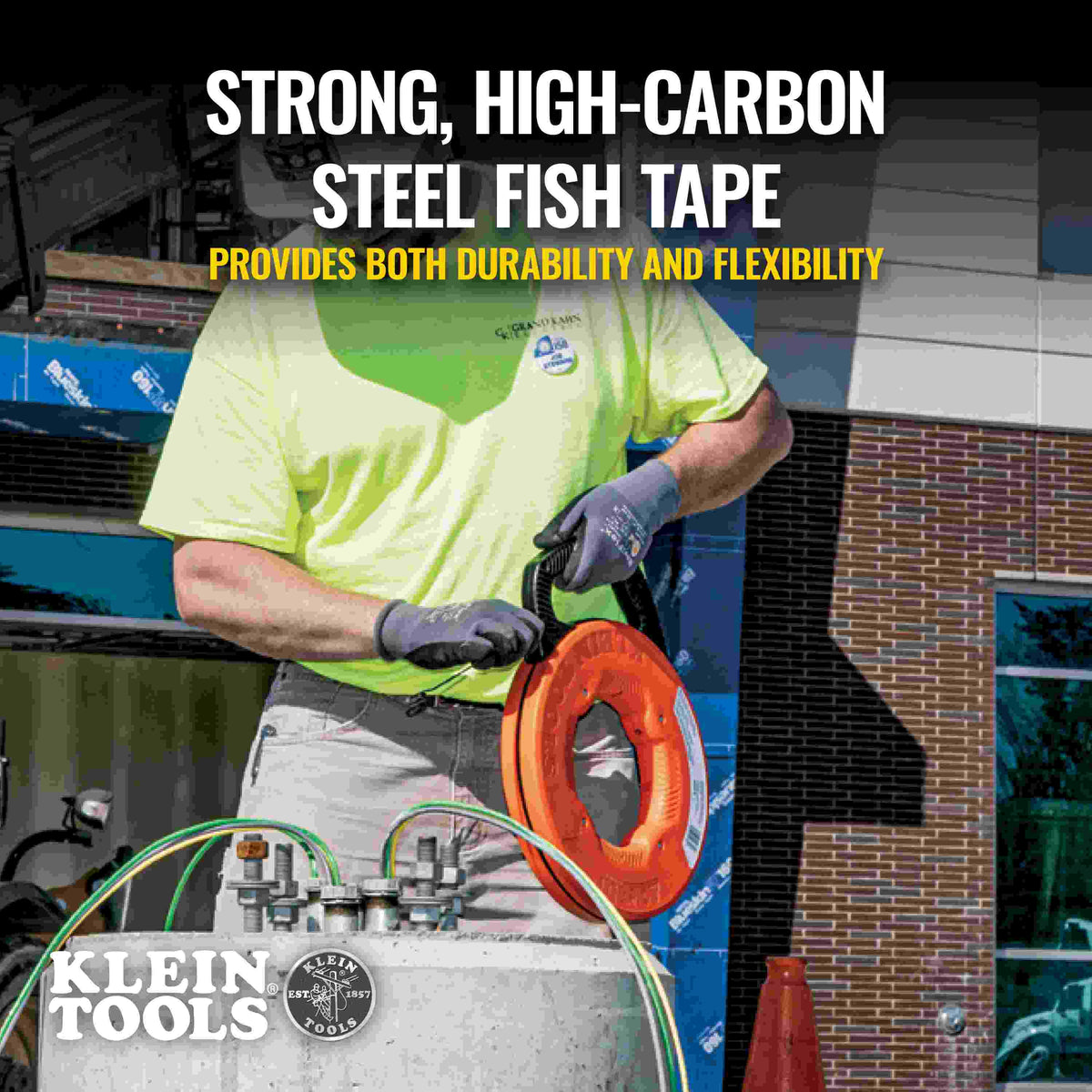 A construction worker wearing gloves using the fish tape outdoors, with text overlay stating strong high-carbon steel provides durability and flexibility.