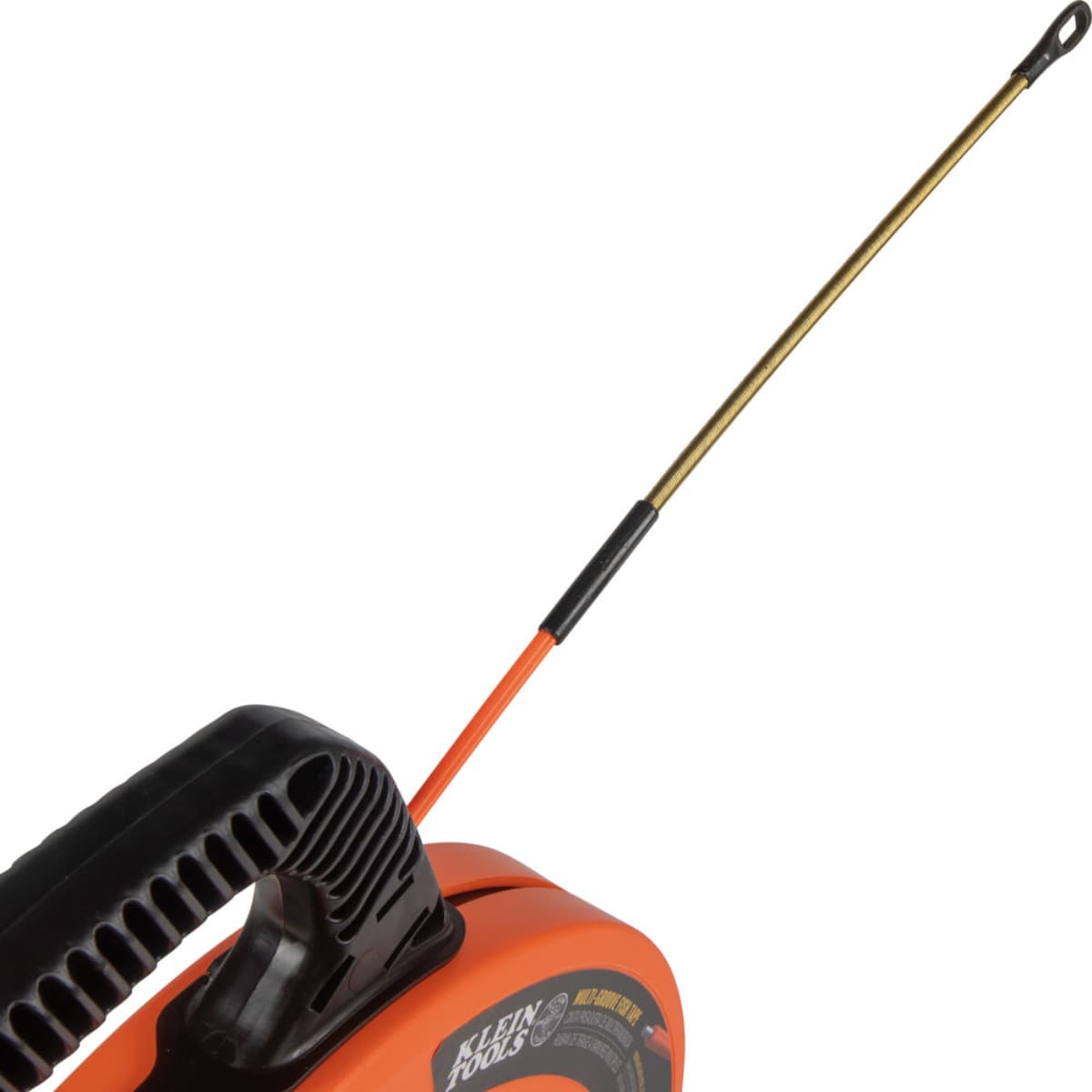Close-up of the 7-inch spiral steel leader on the Klein Tools fish tape, designed with high flexibility to maneuver past existing wires and through multiple bends in a conduit run.