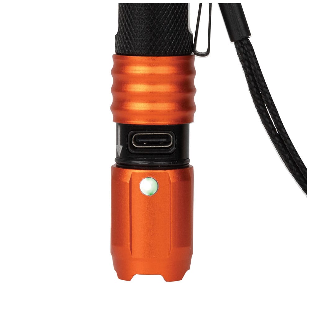 Close-up view of the flashlight with the orange protective collar slid down to reveal the integrated USB-C charging port and the battery life indicator glowing green to signal a full charge.