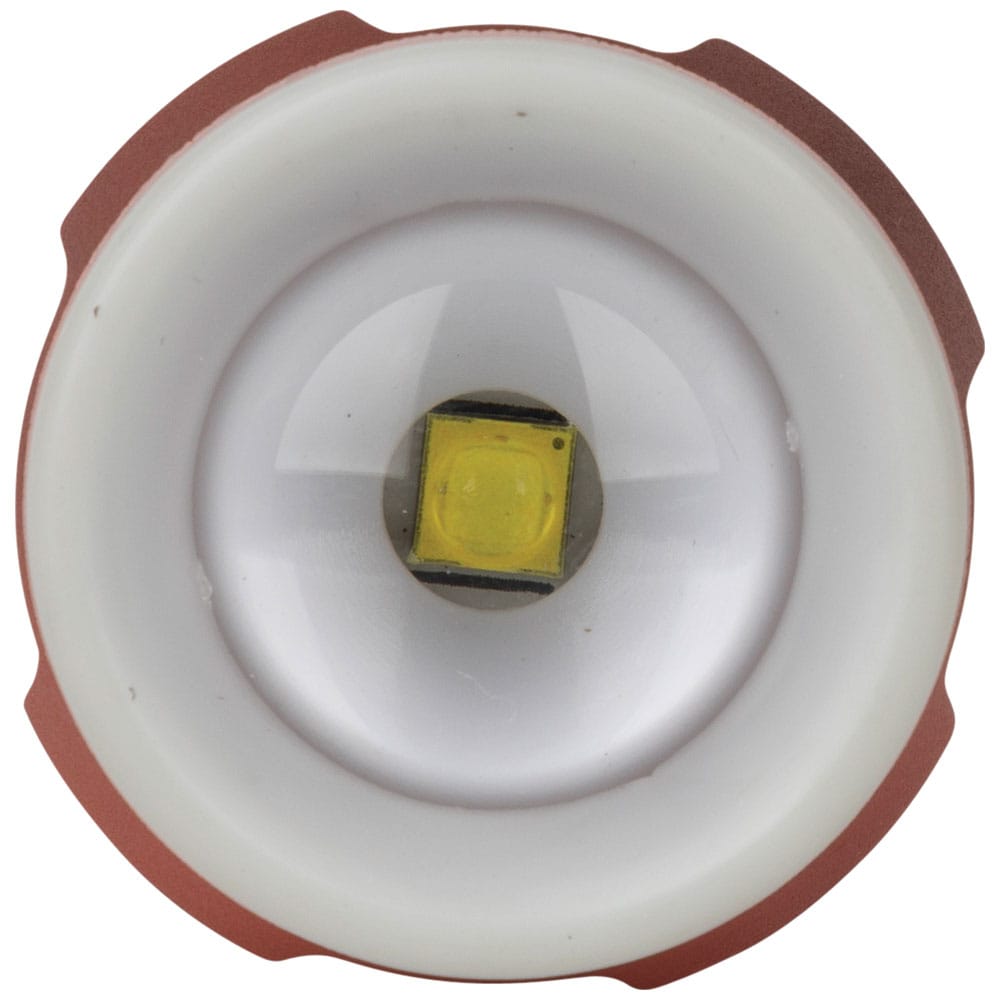 Close-up of the front lens on the Klein 56412 LED flashlight, displaying the primary LED bulb surrounded by the luminescent glow ring locator bezel.