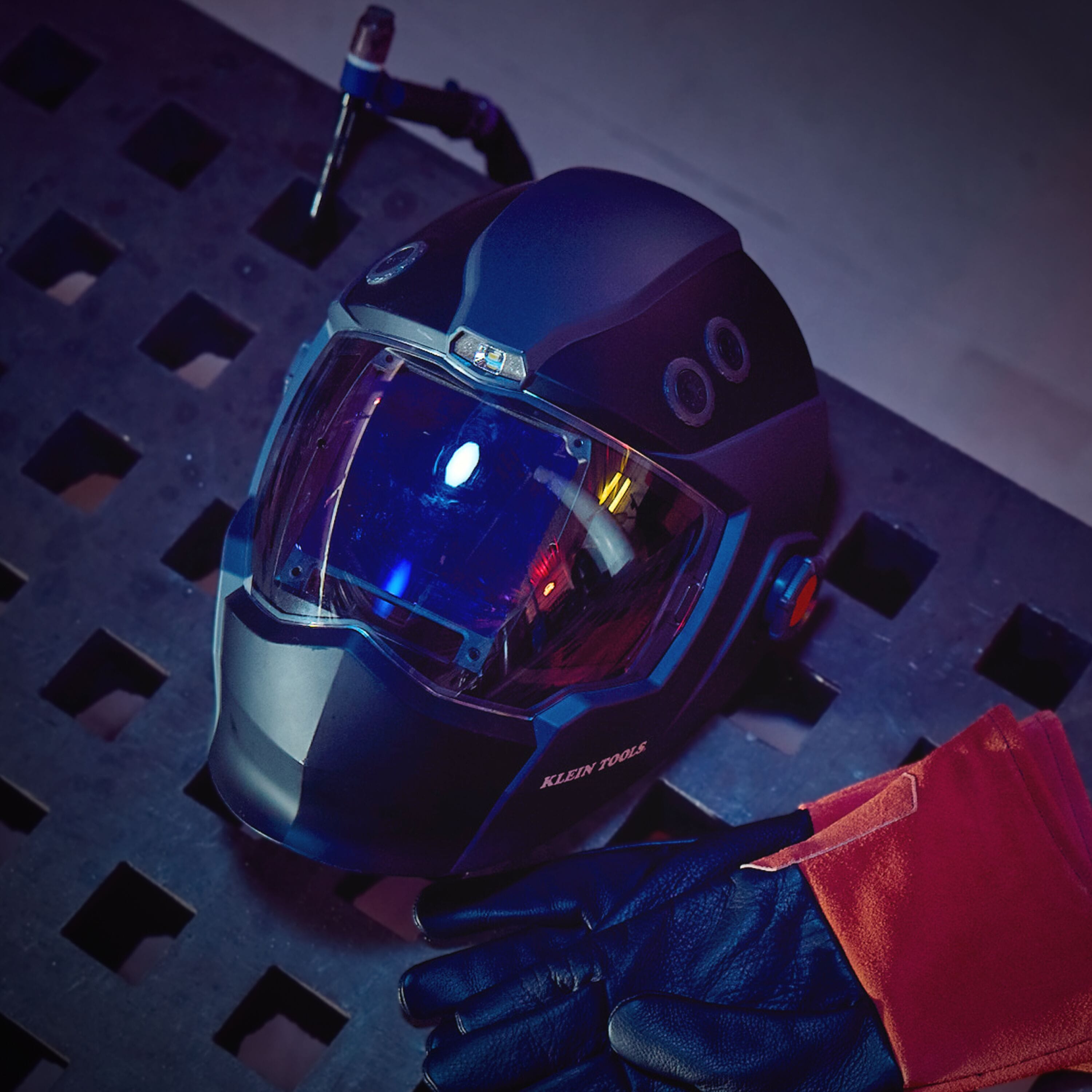 Close-up of a futuristic helmet with a reflective visor on a dark background