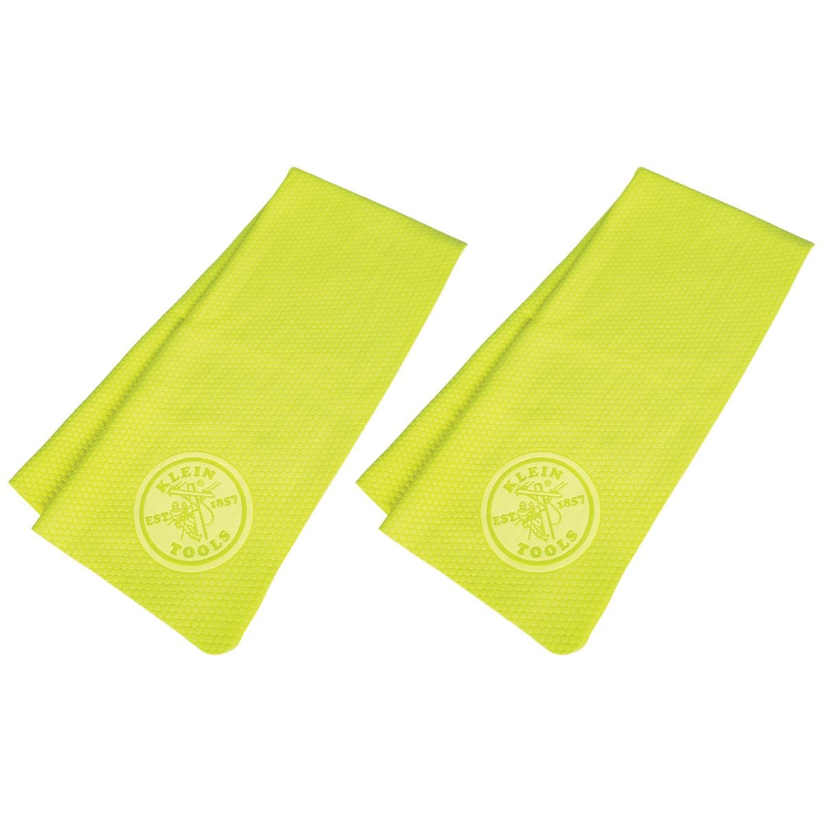 A studio product shot showcasing two high-visibility yellow Klein Tools 60486 PVA cooling towels folded and laid flat side-by-side against a white background, featuring a subtle embossed circular Klein Tools logo near the lower edge of each towel.