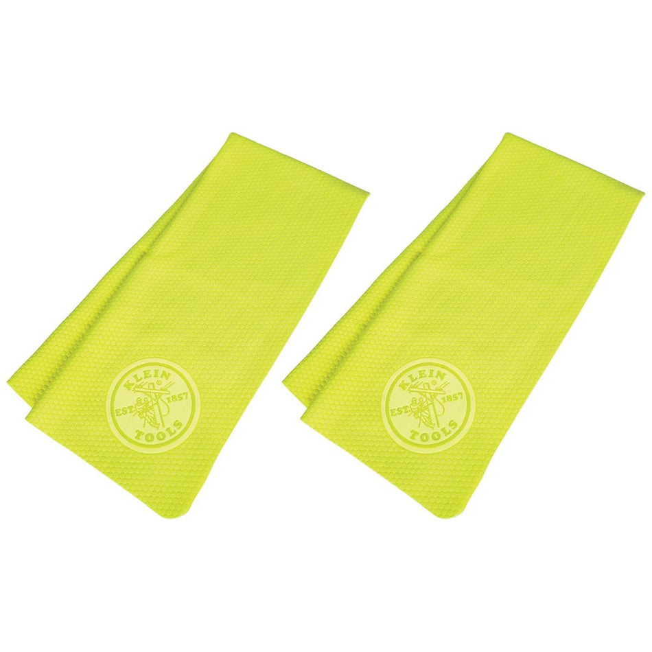 A studio product shot showcasing two high-visibility yellow Klein Tools 60486 PVA cooling towels folded and laid flat side-by-side against a white background, featuring a subtle embossed circular Klein Tools logo near the lower edge of each towel.
