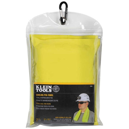 A product retail packaging shot showing the Klein Tools 60486 cooling PVA towel 2-pack enclosed inside its clear plastic pouch, featuring a top-mounted black utility carabiner clip and a lower informational label displaying a construction worker utilizing the neck wrap.