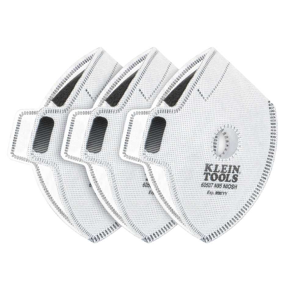 Three-pack of white Klein Tools 60507 N95 replacement filters for reusable face masks, showing their diamond shape, central exhalation valve port, grey hook-and-loop fastening patches, and official NIOSH approval markings.