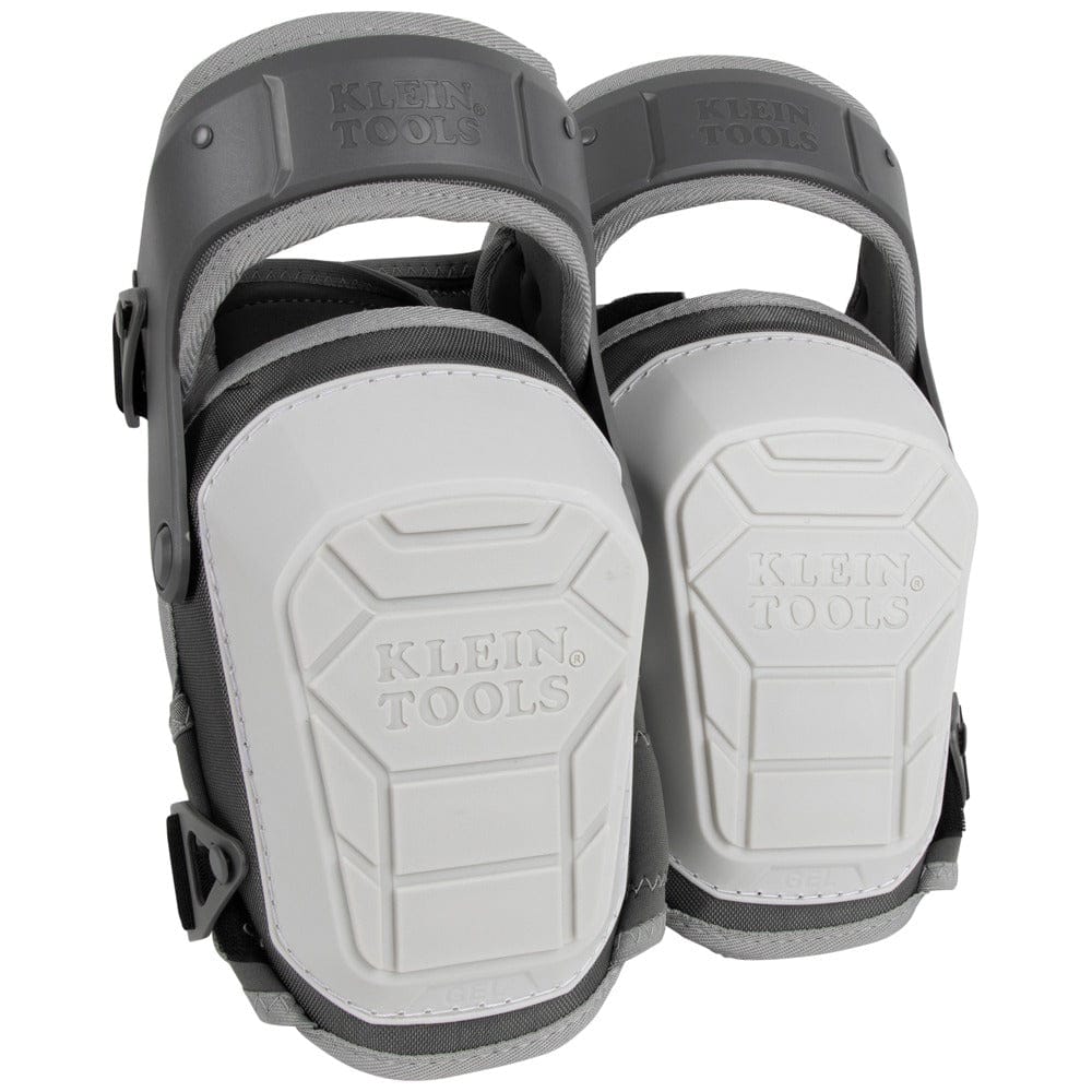 A pair of Klein Tools 60897 heavy-duty stabilizer knee pads shown from a front-facing perspective. The image highlights the large, white, non-marring shells with the Klein Tools logo and the protective gray hinged thigh straps.