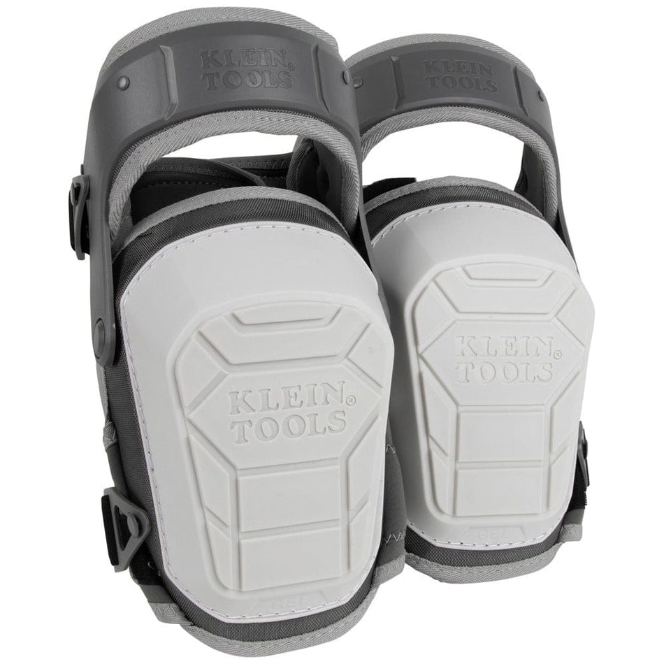 A pair of Klein Tools 60897 heavy-duty stabilizer knee pads shown from a front-facing perspective. The image highlights the large, white, non-marring shells with the Klein Tools logo and the protective gray hinged thigh straps.