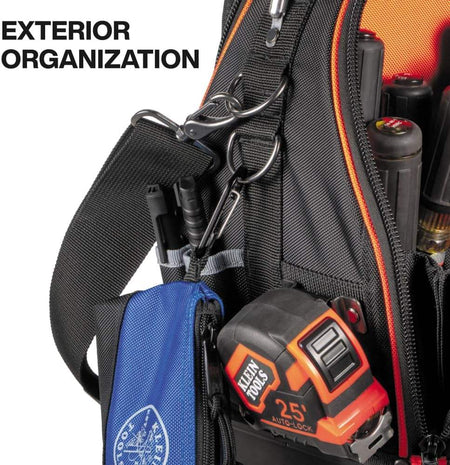 Close-up of the bag's side showing exterior organization options including a tape measure clip and D-ring for hanging accessories.
