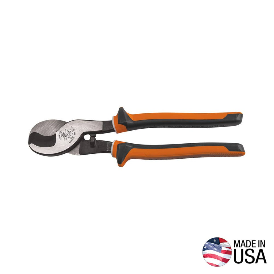 A professional side profile of the Klein Tools 63013 insulated cable cutter, featuring high-dielectric orange and black handles with integrated thumb guards and induction-hardened forged steel jaws, with a Made in USA logo.