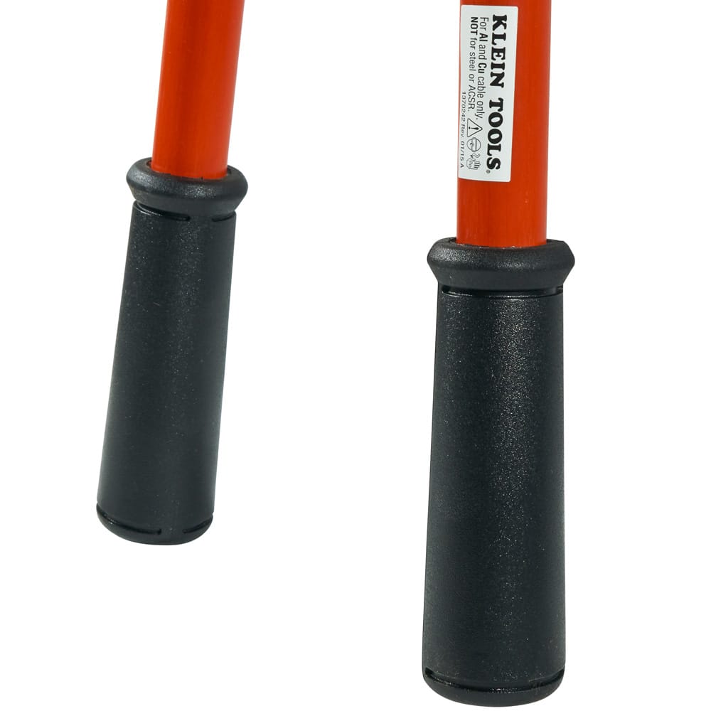 Detailed shot of the ergonomic black vinyl handle grips on the high-visibility orange fiberglass handles, highlighting the professional-grade non-slip finish and the safety warning label affixed to the handle.