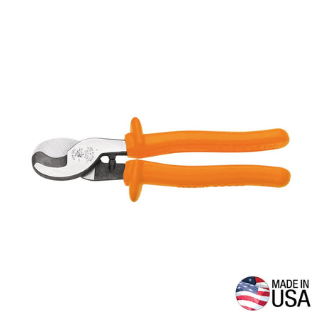 A professional side profile of the Klein Tools 63050-INS insulated cable cutter, featuring high-dielectric orange handles with integrated thumb guards and induction-hardened forged steel jaws designed for one-handed shear cutting, with a Made in USA logo.