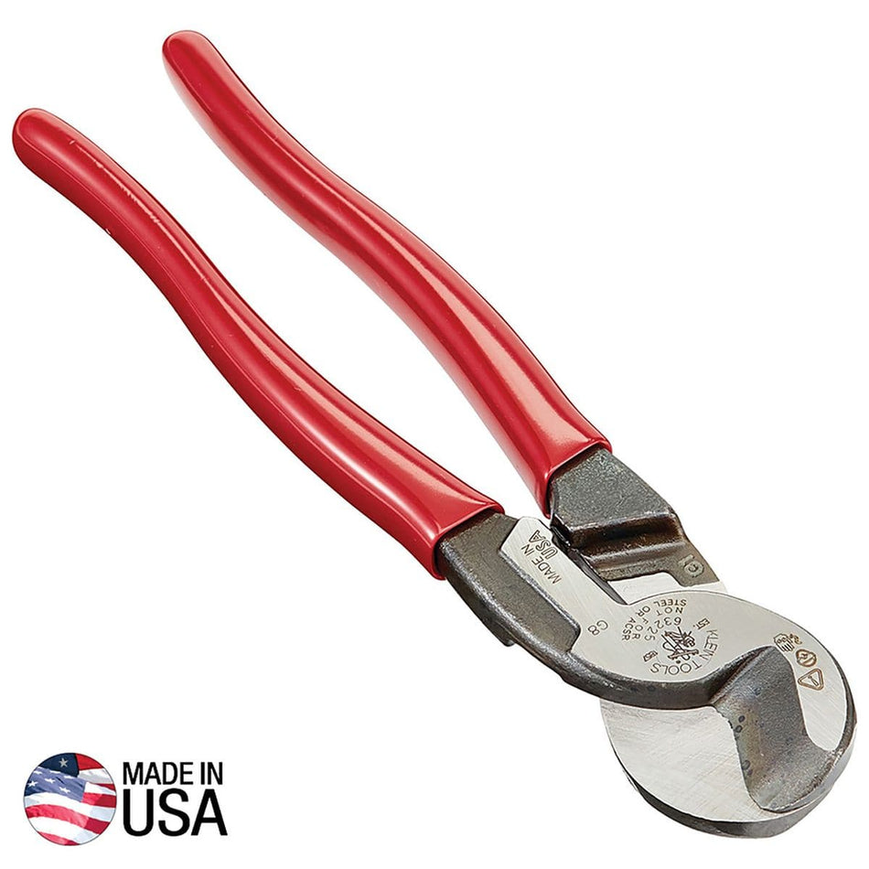 A professional side profile of the Klein Tools 63225 high-leverage cable cutter, featuring red plastic-dipped handles and precision-ground forged steel jaws designed for one-handed shearing of aluminum and copper cable, with a Made in USA logo.