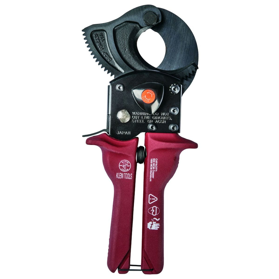 A professional side profile of the Klein Tools 63601 compact ratcheting cable cutter, featuring high-leverage gearing, ergonomic red handles with hand guards, and induction-hardened forged steel jaws designed for one-handed operation.