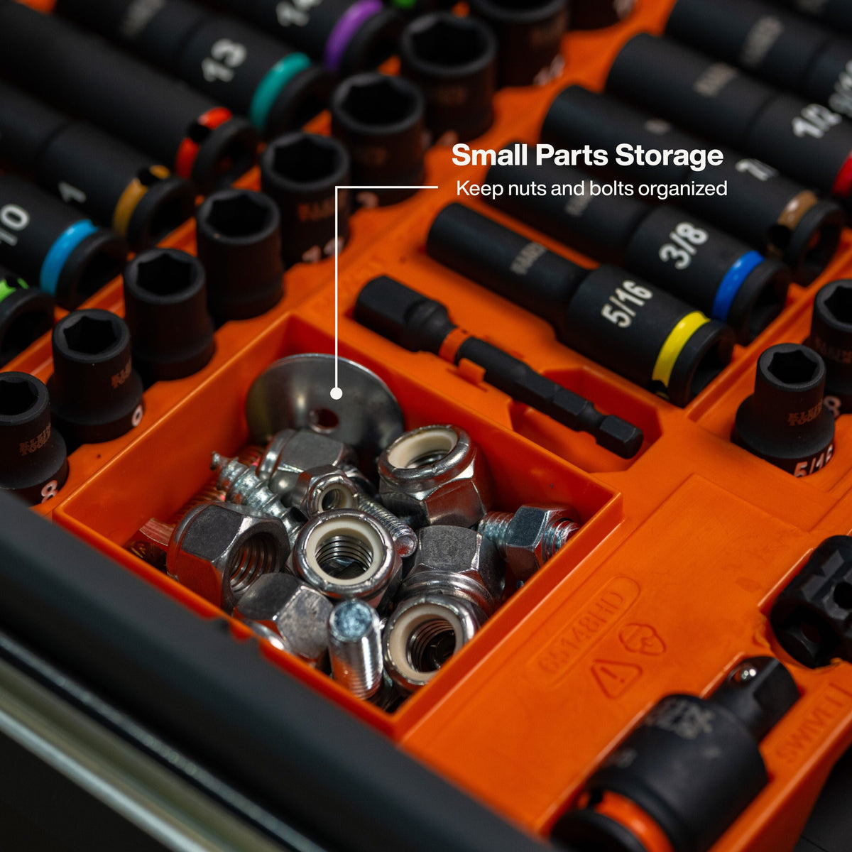 Close-up view of the integrated small parts storage compartment within the organizer tray, shown holding various hex nuts and metal washers alongside the 3/8-inch drive impact sockets.