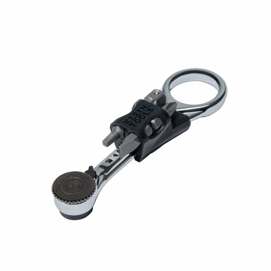 A profile shot of the Klein Tools 65200MAG magnetic mini ratchet featuring a high-strength chromium vanadium steel body with a polished chrome finish and a removable black bit storage carrier holding four essential driver bits.