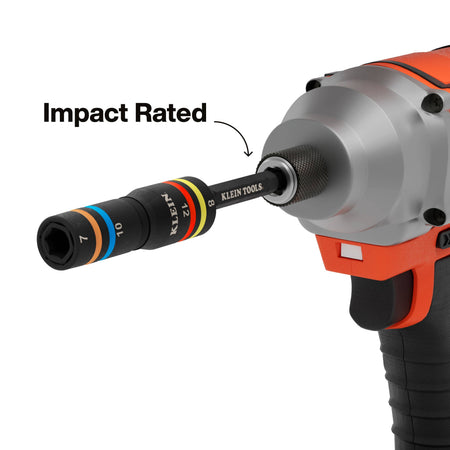 A functional demonstration of the impact-rated quad socket attached to a cordless impact driver, showcasing the 1/4-inch drive connection and the professional-grade steel construction designed for high-torque applications.