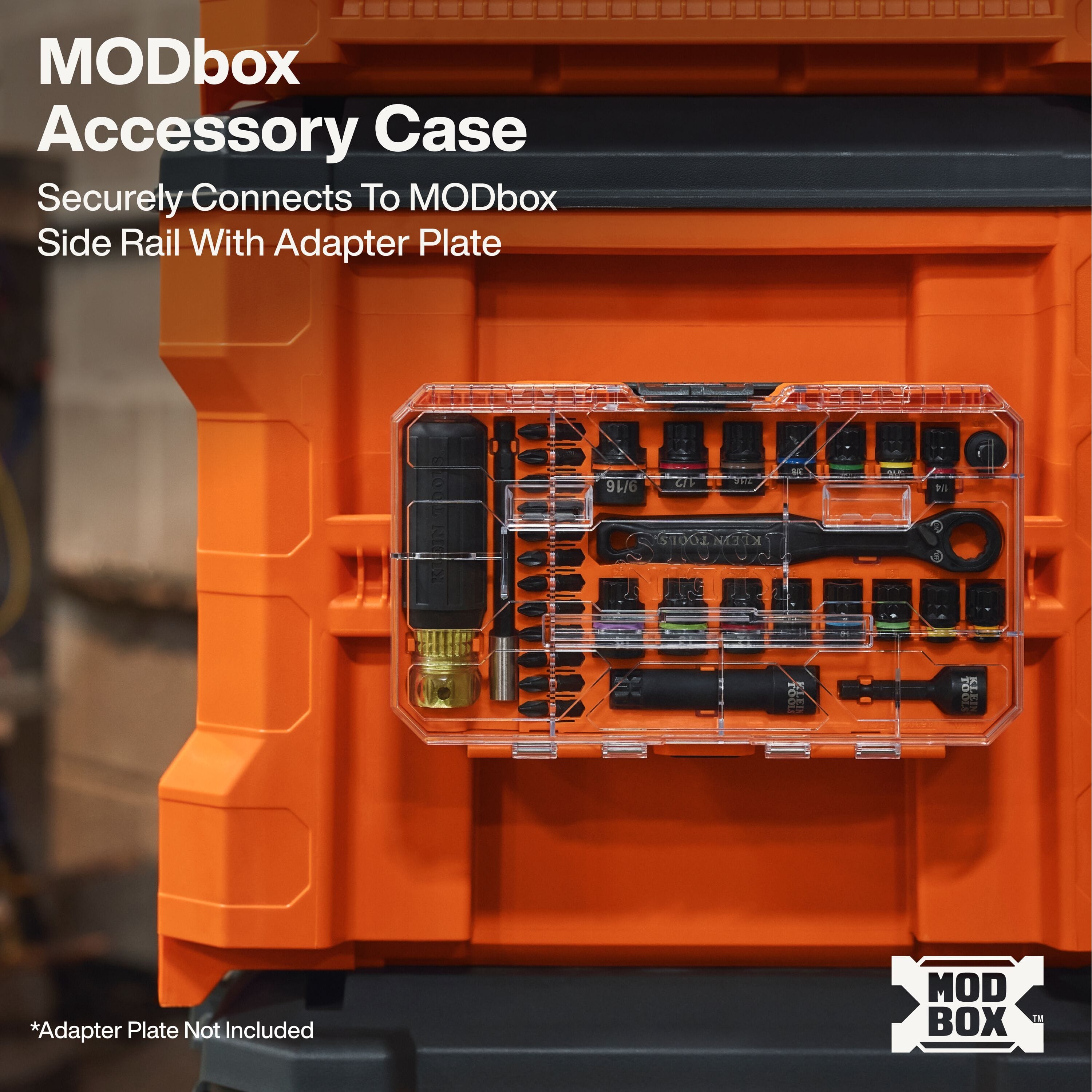 A practical application view of the KNECT 33-piece impact socket set MODbox accessory case mounted externally to the side rail of a large orange Klein Tools rolling tool box, demonstrating secure, high-visibility storage on a professional job site.