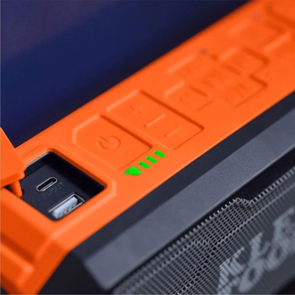 Detail shot of the top control panel showing the illuminated green battery level indicators and the open port cover revealing USB-C and USB-A charging ports.