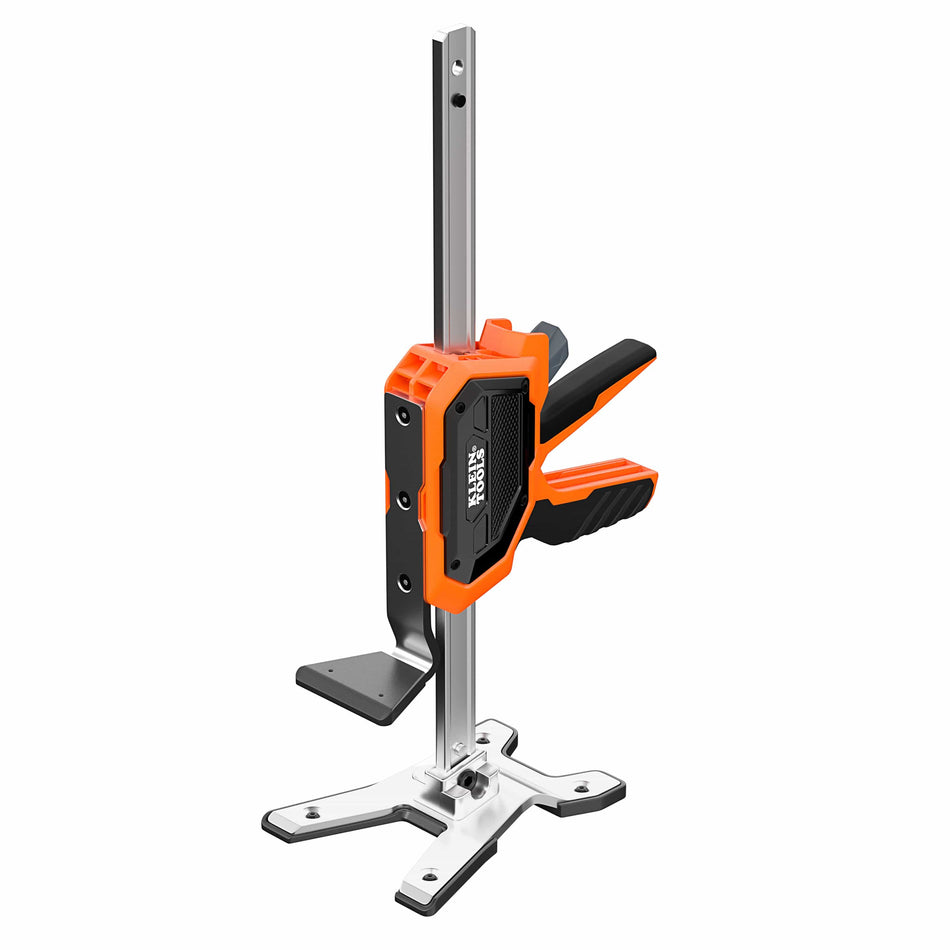 A professional product shot of the Klein Tools 77000 heavy-duty construction jack, featuring a reinforced steel I-beam frame, high-visibility orange housing, and precise manual control levers for industrial lifting and leveling.